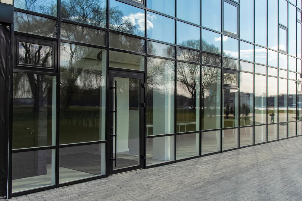 A Glass Railing With Stainless Steel Posts On A Balcony — Scratchless Glass Australia in Maroochydore, QLD