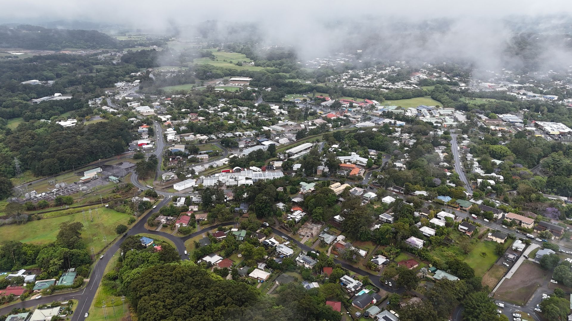 Aerial View of a Cloudy Town With Green Hills — Scratchless Glass Australia in Nambour, QLD