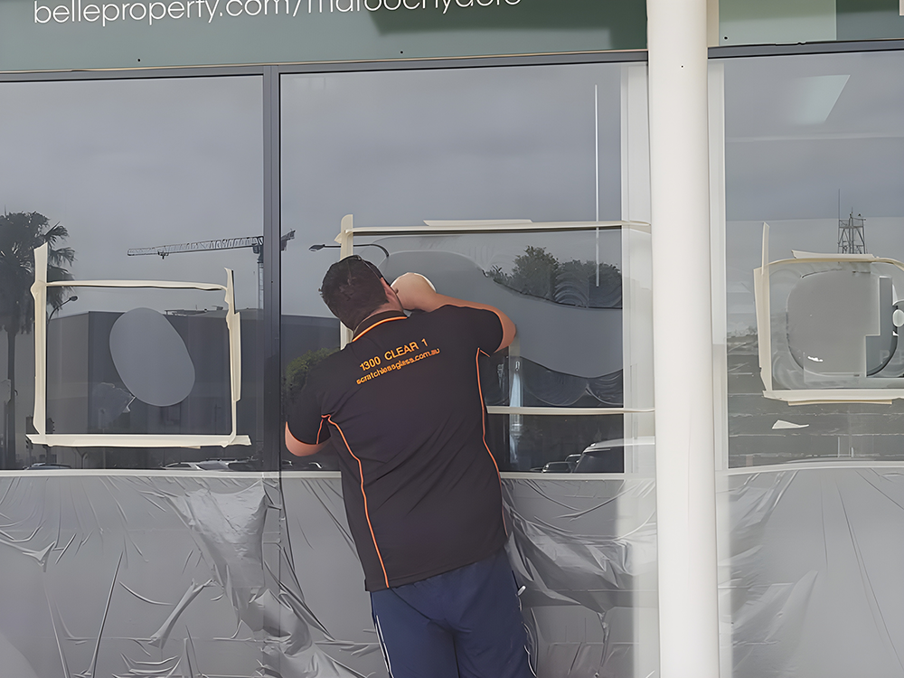 Man Installing Window Graphics on a Storefront