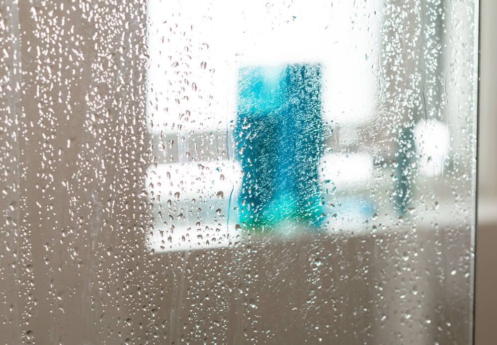 A Close Up Of A Shower Door With Water Drops On It — Scratchless Glass Australia in Nambour, QLD