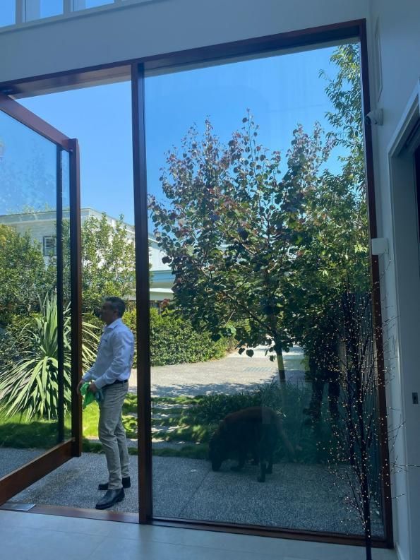 A Building With A Large Glass Door And A Brick Wall — Scratchless Glass Australia in Maroochydore, QLD