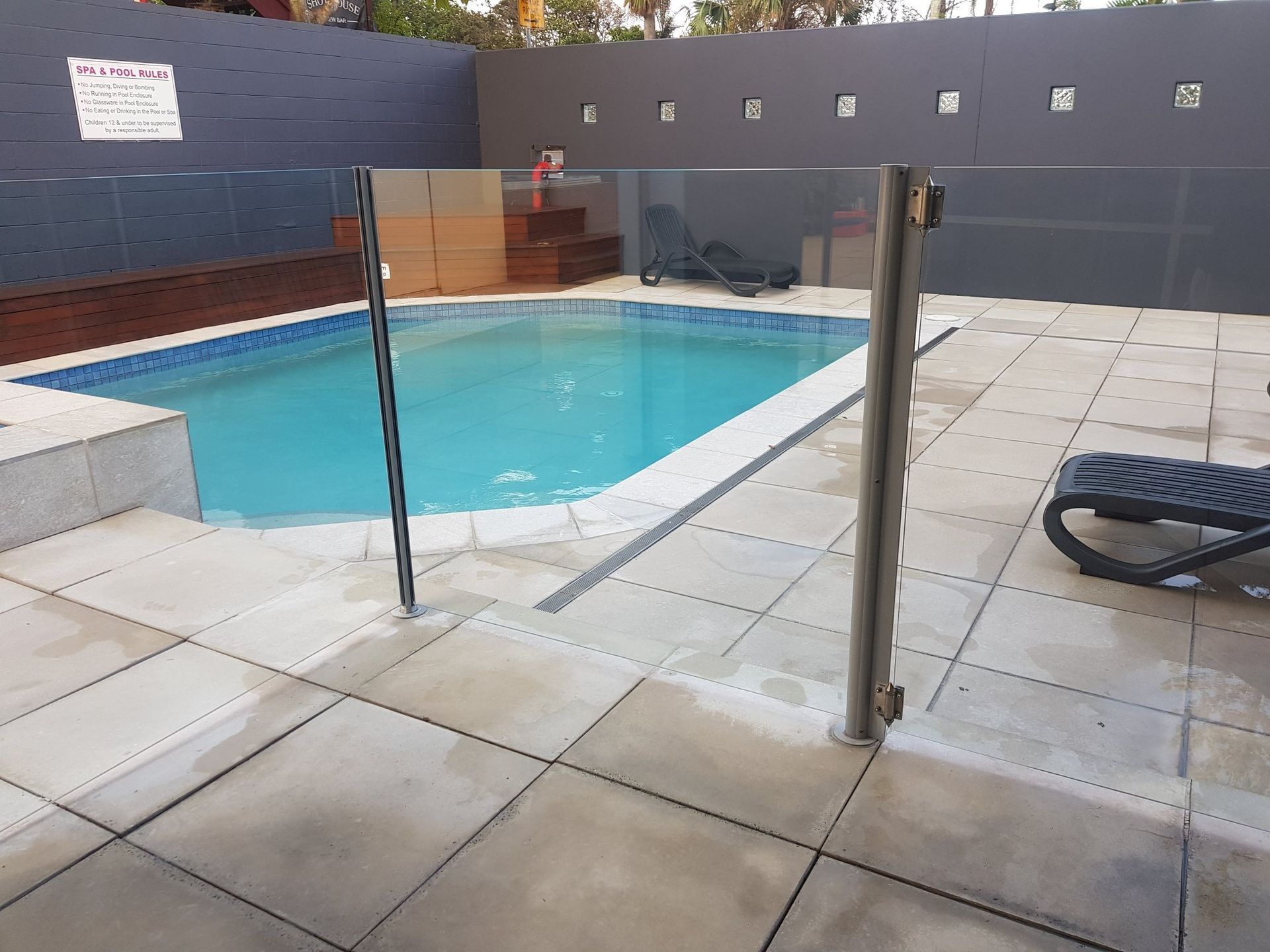 A Large Swimming Pool With A Glass Fence Overlooking The Ocean — Scratchless Glass Australia in Maroochydore, QLD