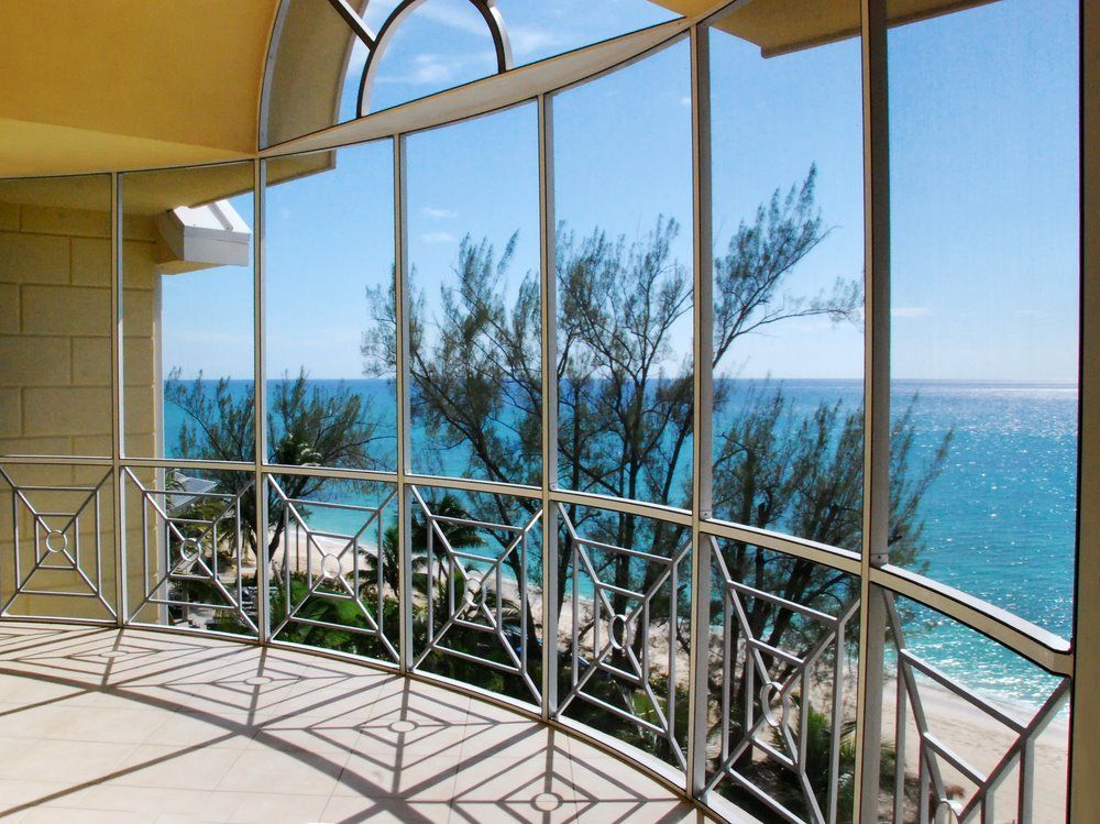 A Glass Railing Is Surrounding A Staircase In A Building — Scratchless Glass Australia in Maroochydore, QLD