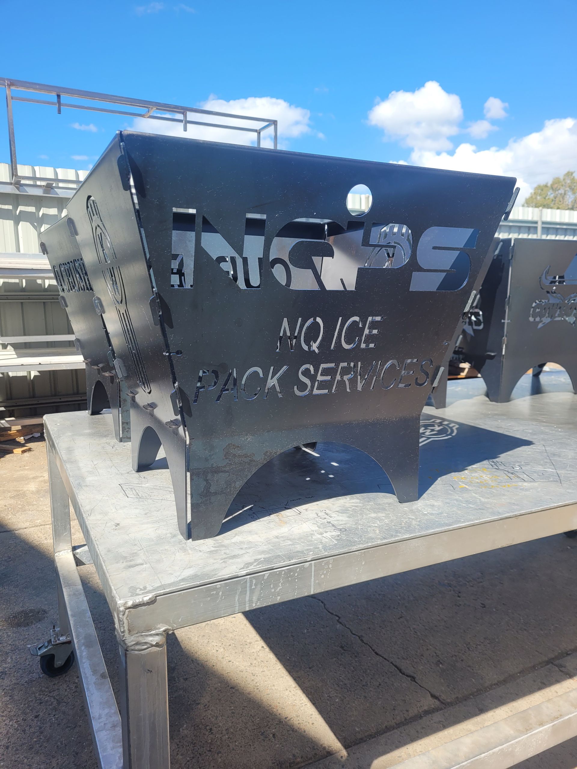 A Row Of Metal Boxes With One That Says NQPS On It — Bigdog Welding and Fabrication Pty Ltd In Currajong, QLD