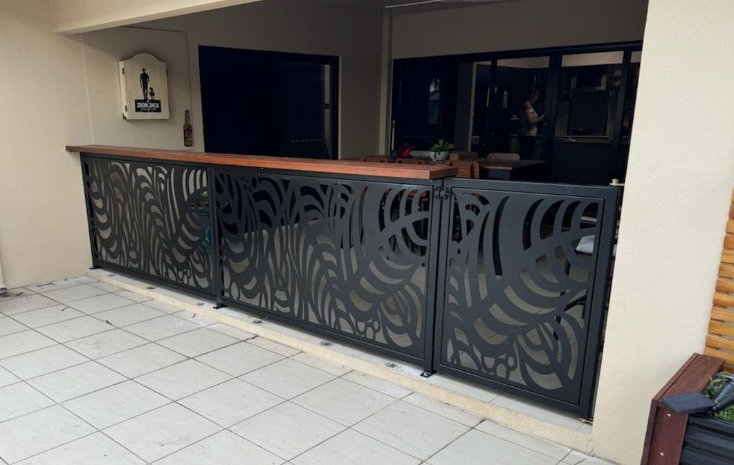 A Balcony With A Metal Railing And A Wooden Bar — Bigdog Welding and Fabrication Pty Ltd In Currajong, QLD