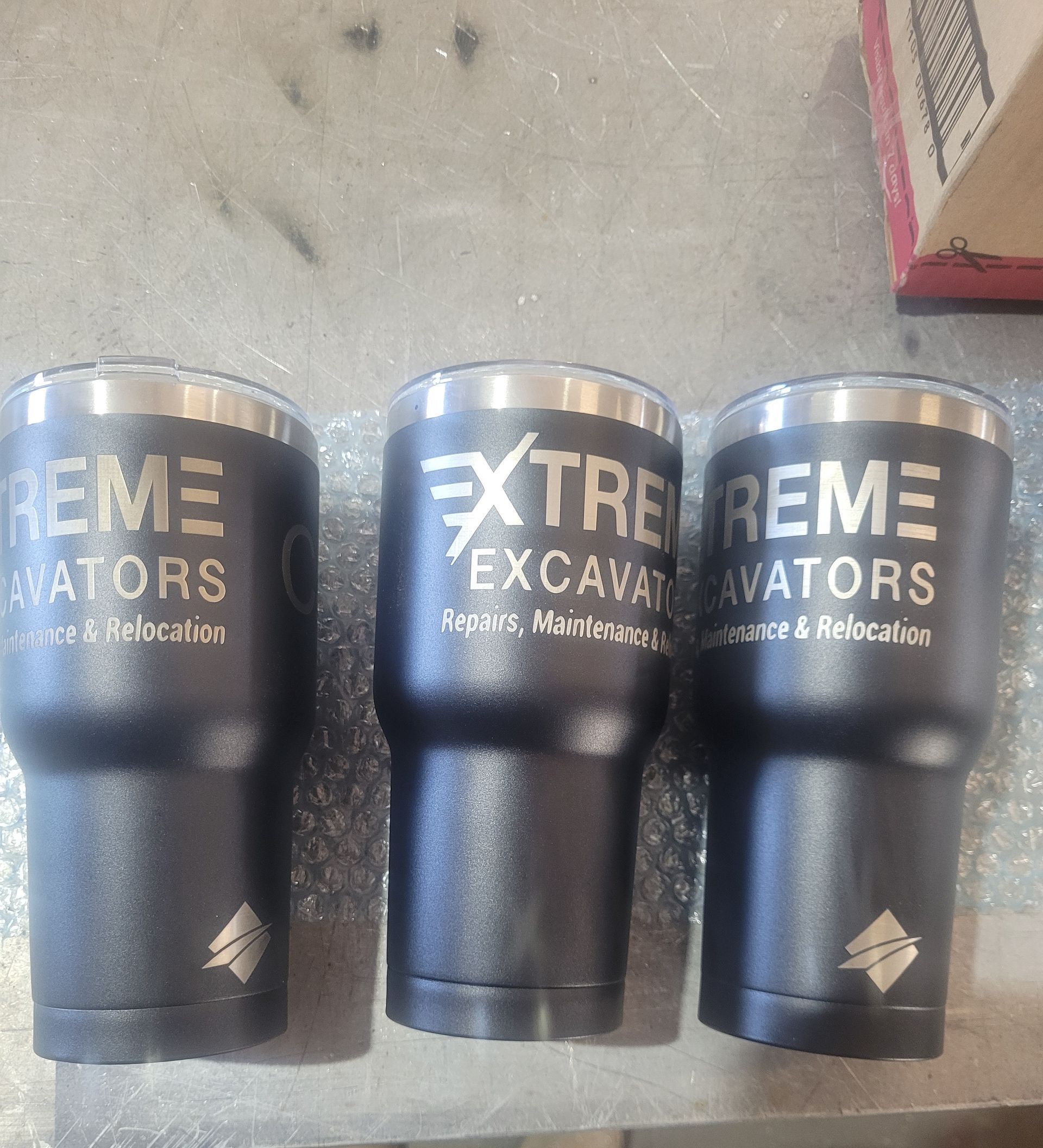 Three Customised Cups With The Writing Extreme Excavators On Them— Bigdog Welding and Fabrication Pty Ltd In Currajong, QLD