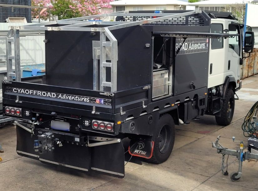 A Truck With A Ramp Attached To It Is In A Garage — Bigdog Welding and Fabrication Pty Ltd In Currajong, QLD