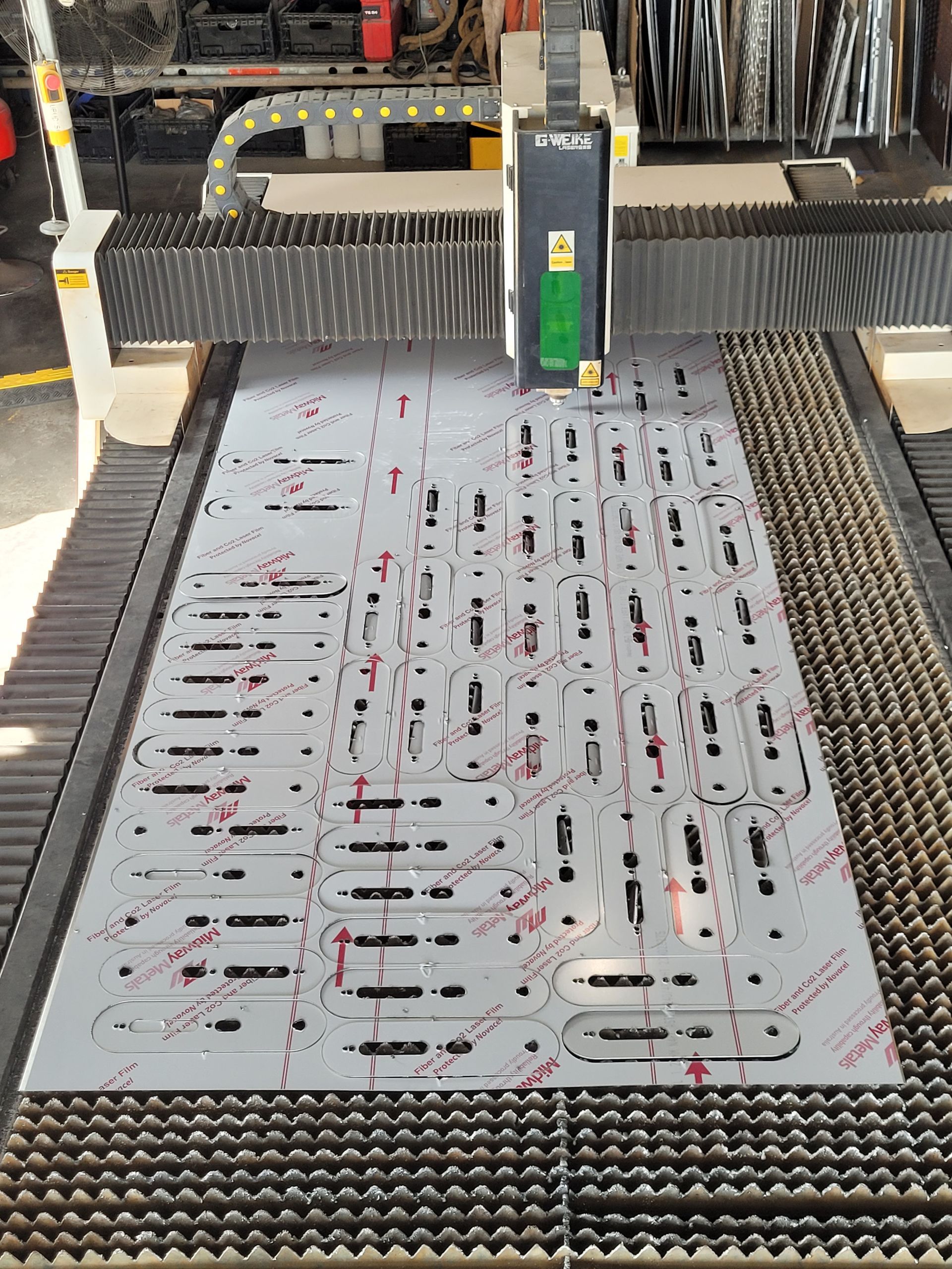 A Machine Is Cutting A Piece Of Metal On A Table — Bigdog Welding and Fabrication Pty Ltd In Currajong, QLD