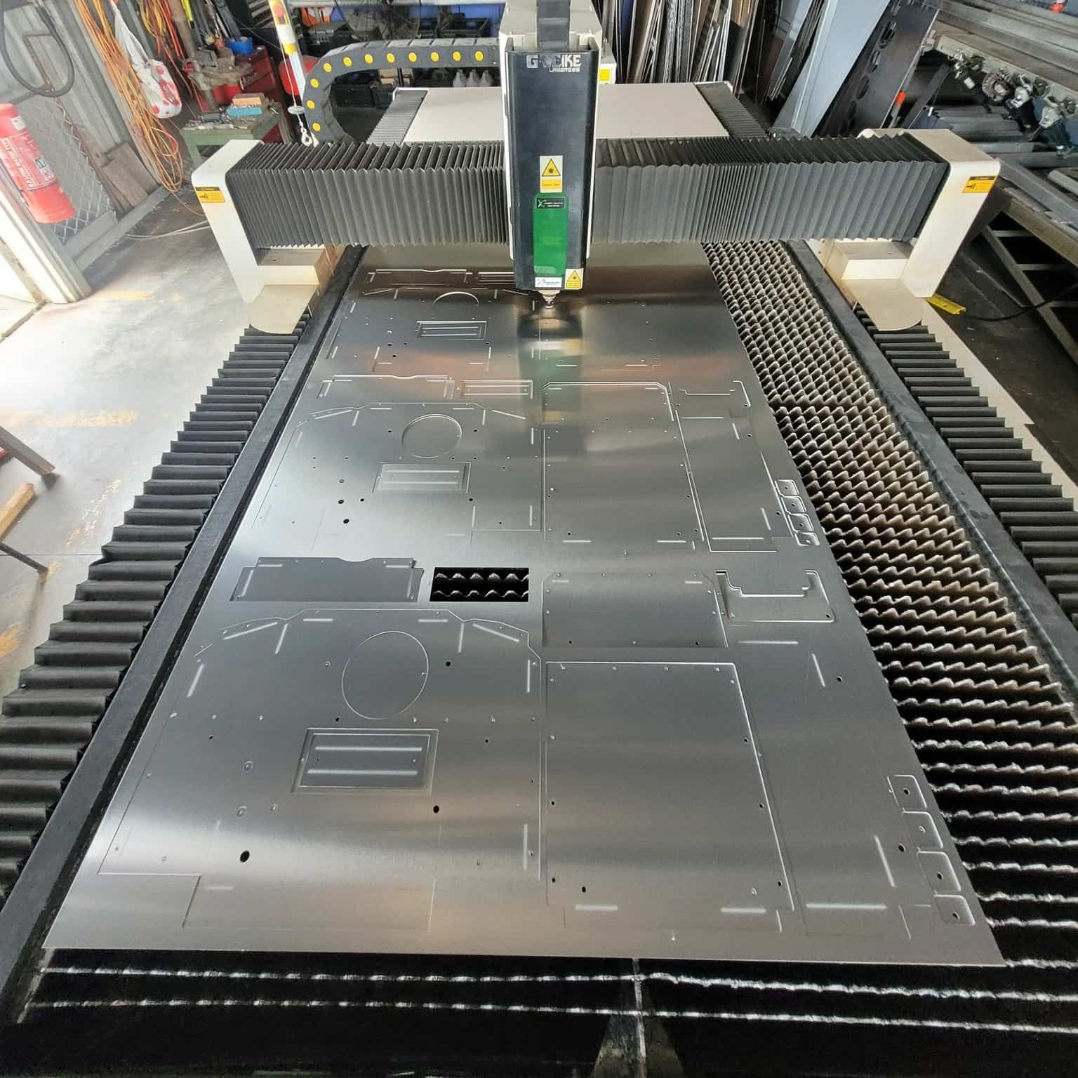 A Machine That Is Cutting A Piece Of Metal — Bigdog Welding and Fabrication Pty Ltd In Currajong, QLD