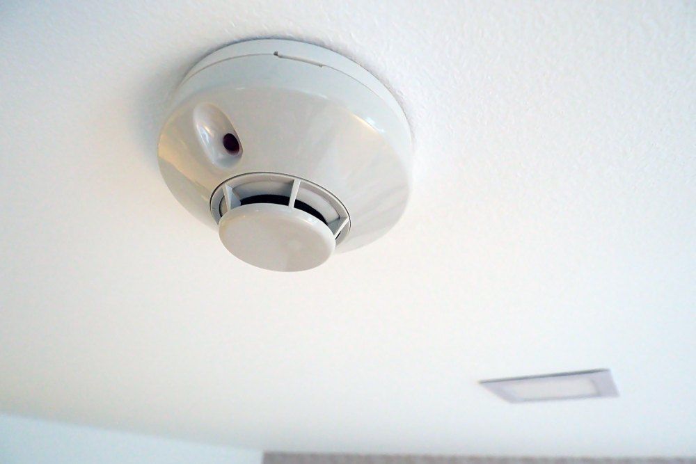 A Smoke Detector is Hanging From the Ceiling of a Room — Brightway Electrical in Ballina, NSW