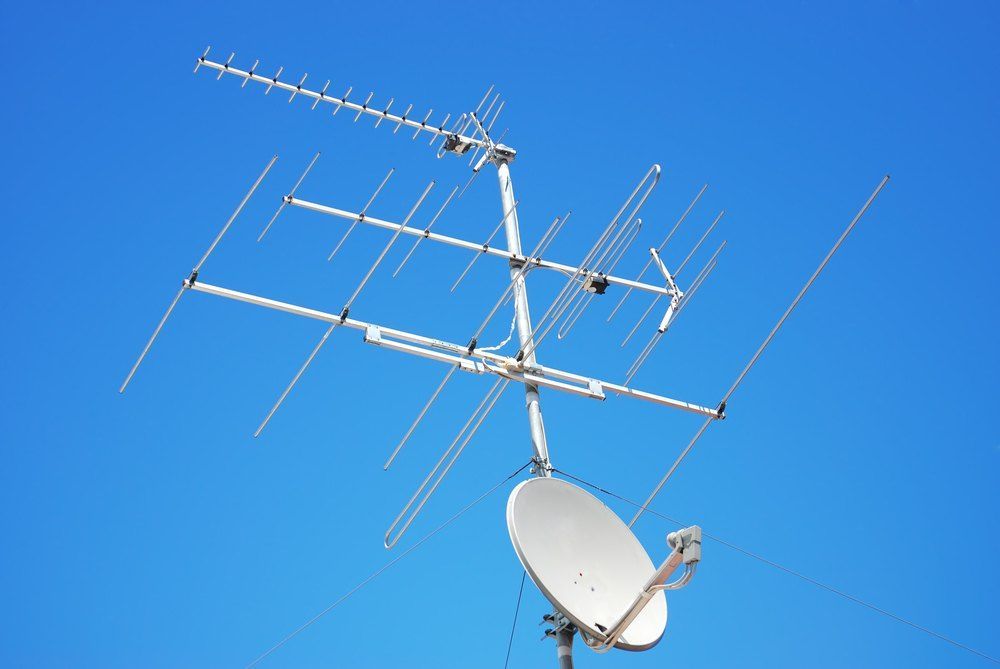 A Large Antenna and Satellite Dish Against a Blue Sky — Brightway Electrical in Ballina, NSW