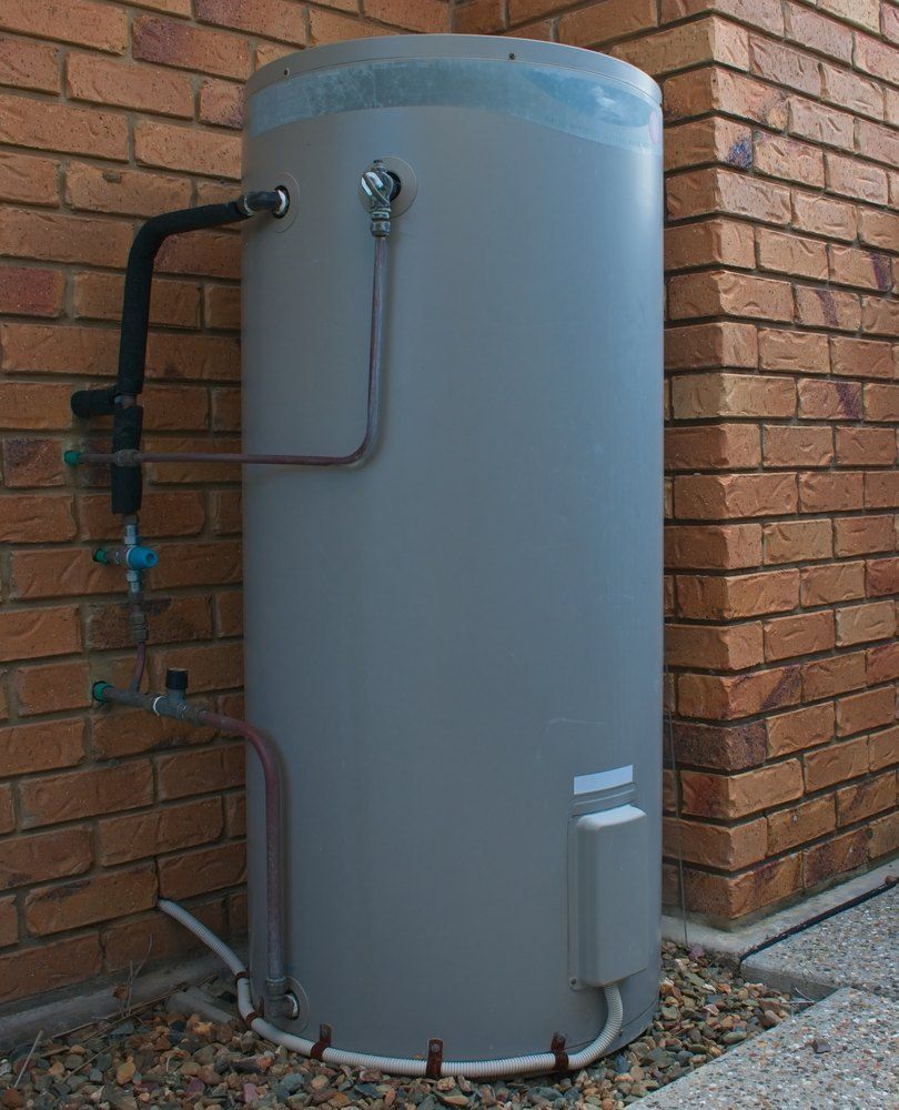 A dark grey hot water tank on outside of home — Brightway Electrical in Ballina, NSW
