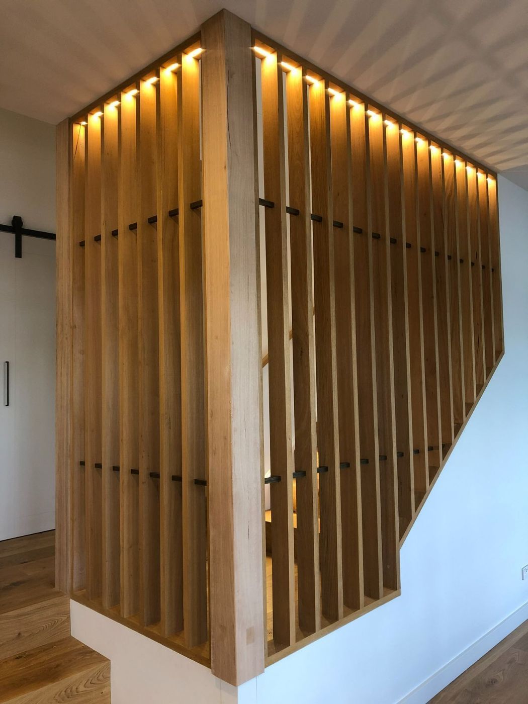 Wooden Slatted Staircase Railing With Warm Lighting — Brightway Electrical in Ballina, NSW