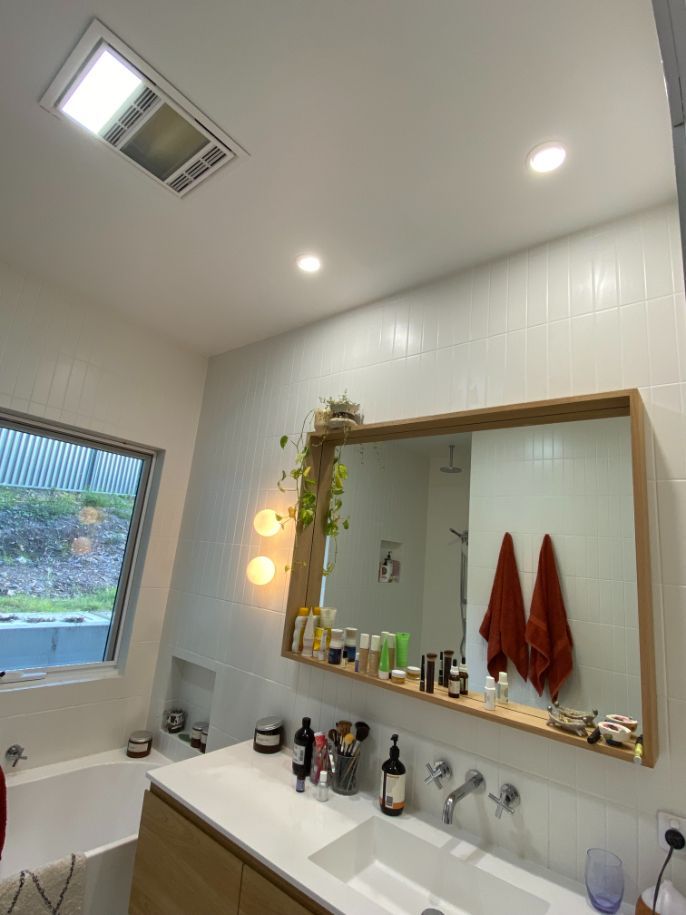 A Bathroom With Two Sinks , a Mirror and a Window — Brightway Electrical in Mullumbimby, NSW