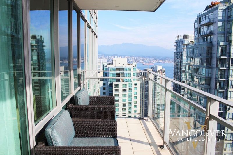 Two balcony chairs on a balcony on a sunny day on an apartment complex 