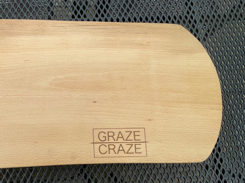 Wooden grazing board with rounded edges, the words