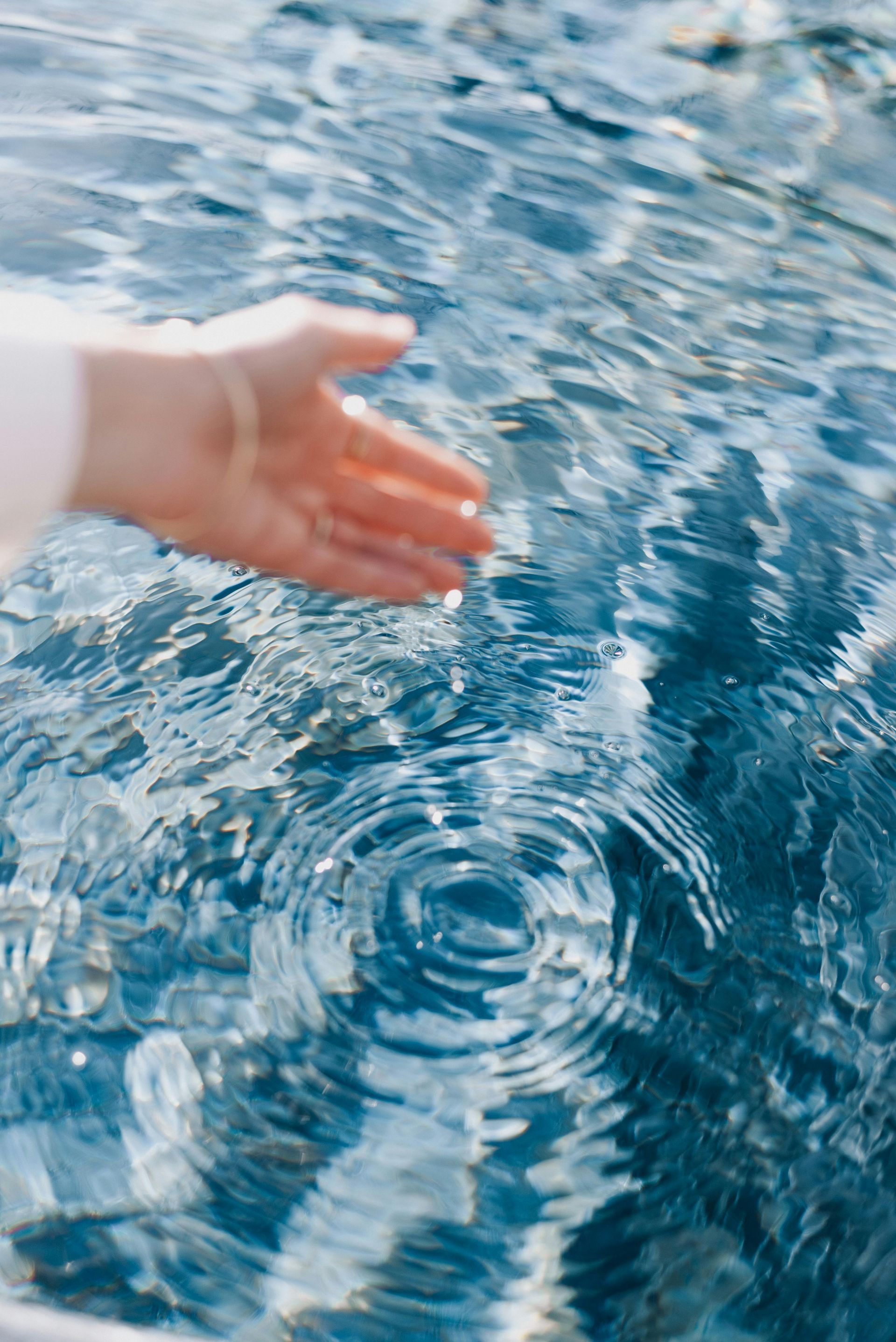 A person is touching the water with their hand.