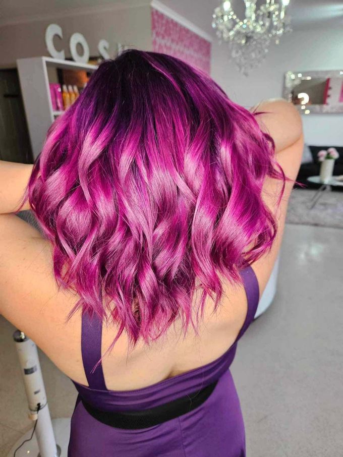 A Woman With Purple Hair is Wearing a Purple Dress — Cosmo Hair & Beauty In Nambour, QLD