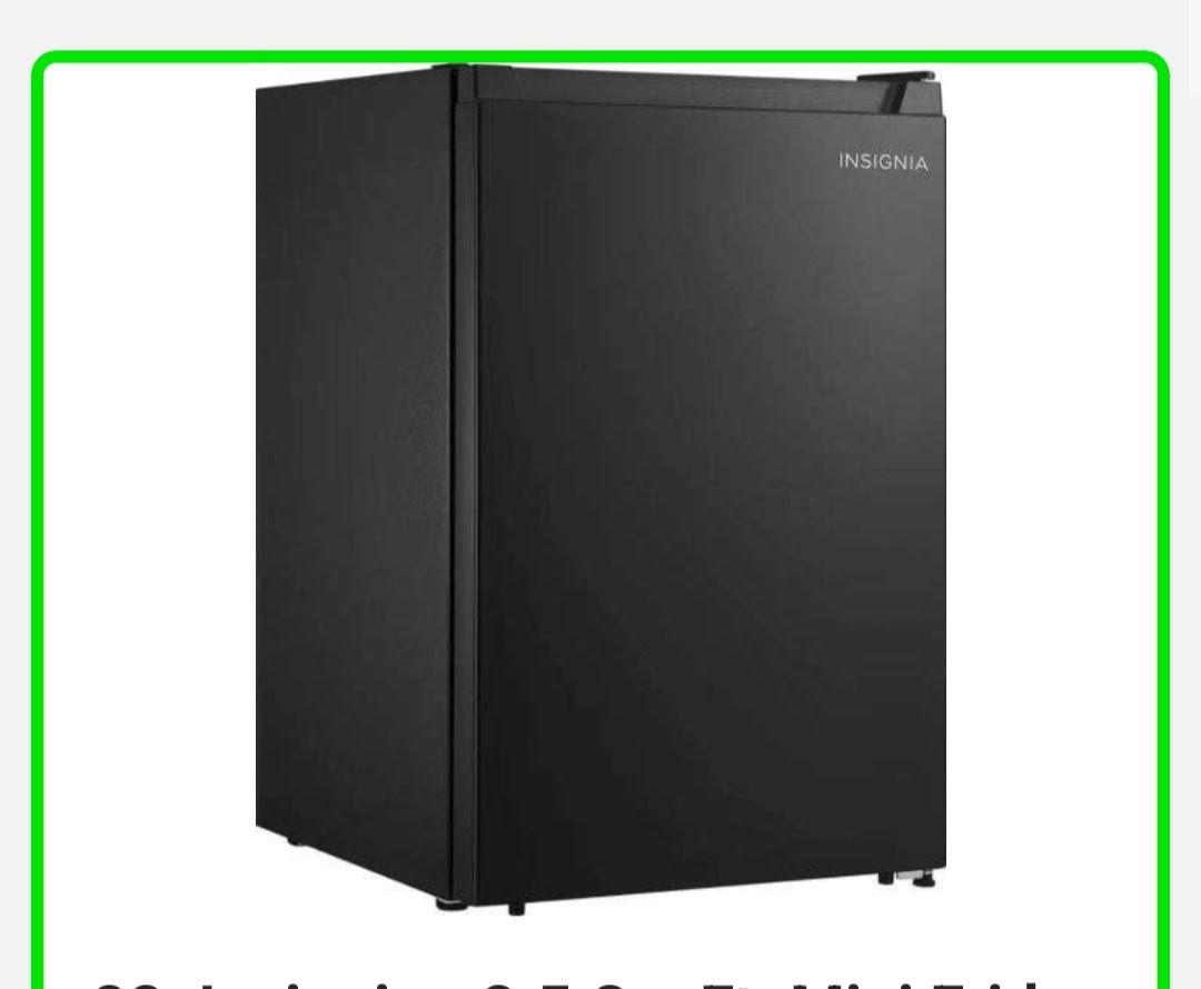 Black mini refrigerator with a handle, sitting in a room.