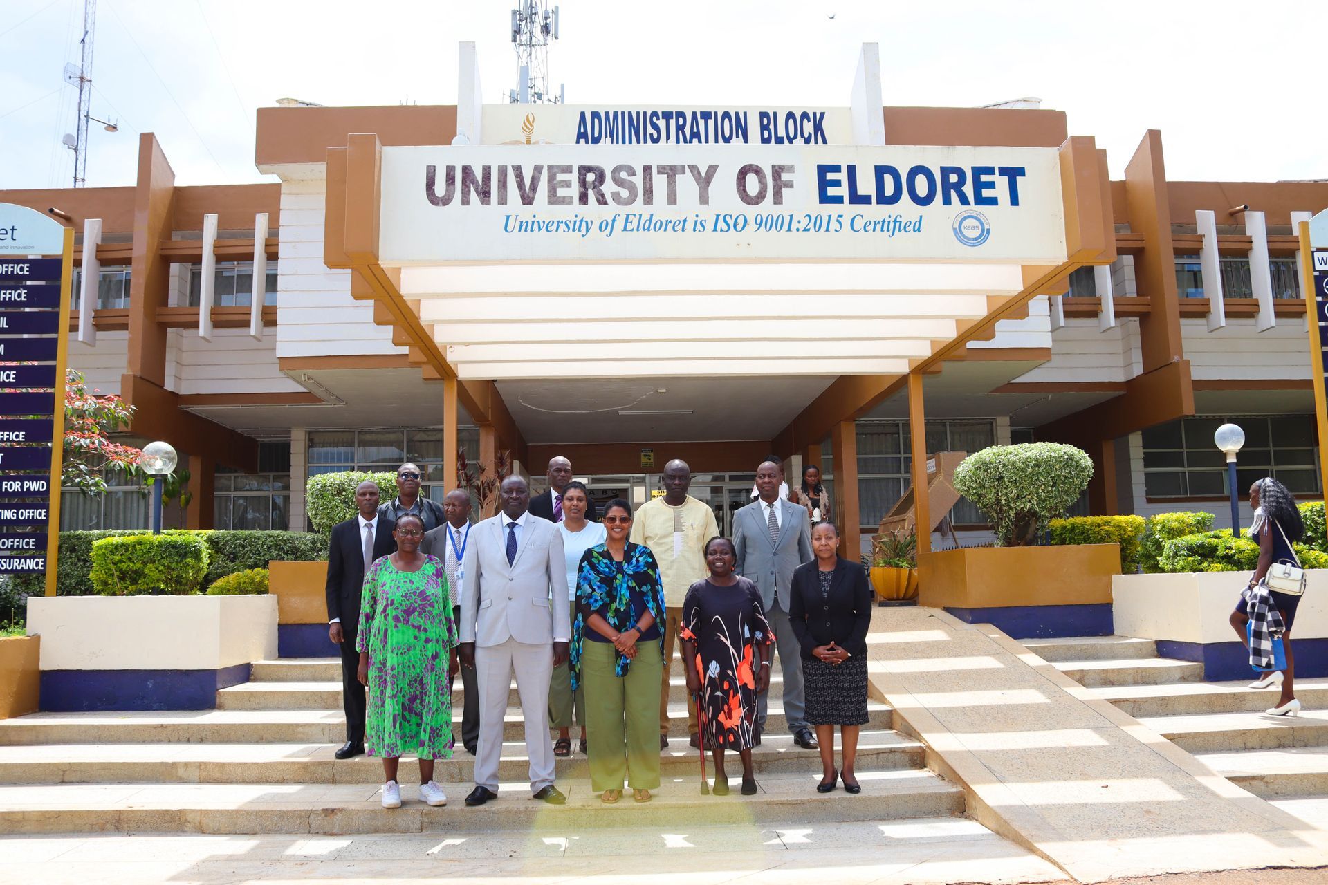 Group of people in front of University of Eldoret building.