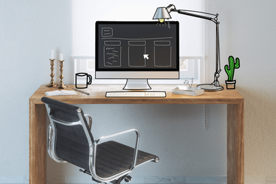 A wooden desk with a chair and a computer on it.
