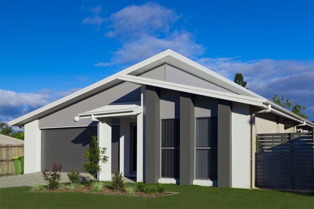 Modern Home With Gray and White Exterior Against a Blue Sky — Diamond Real Estate QLD in North Lakes, QLD