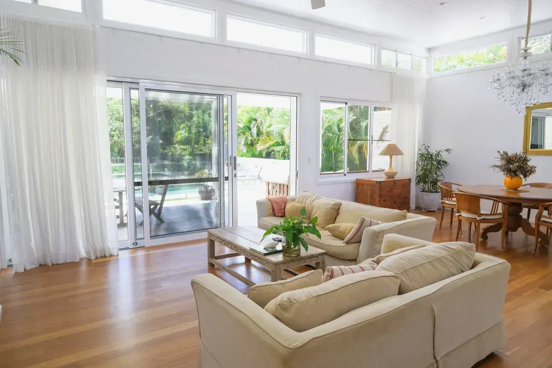 Bright Living Room With Open Sliding Glass Doors Leading to Patio — Diamond Real Estate QLD in North Lakes, QLD