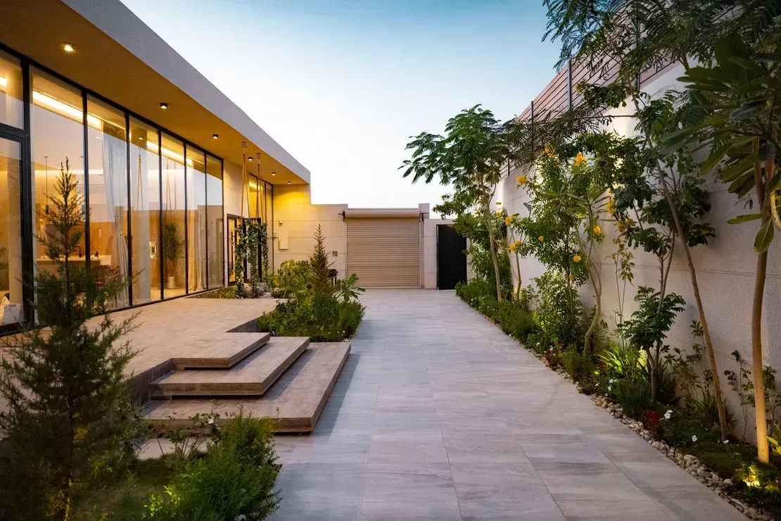 Modern Home Exterior With Large Windows, Paved Walkway, and Landscaping — Diamond Real Estate QLD in North Lakes, QLD