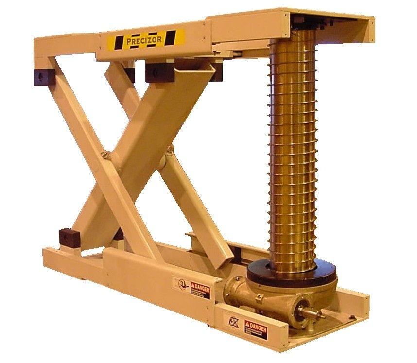 A tan, industrial scissor lift mechanism with a prominent gold-colored vertical threaded screw drive for height adjustment.