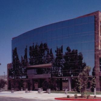 A large building with a lot of windows and trees in front of it