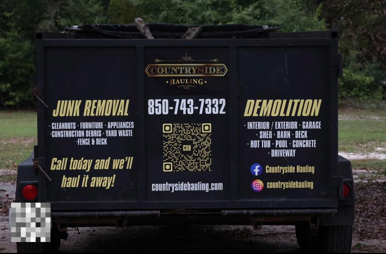 A black trailer that says junk removal and demolition on it