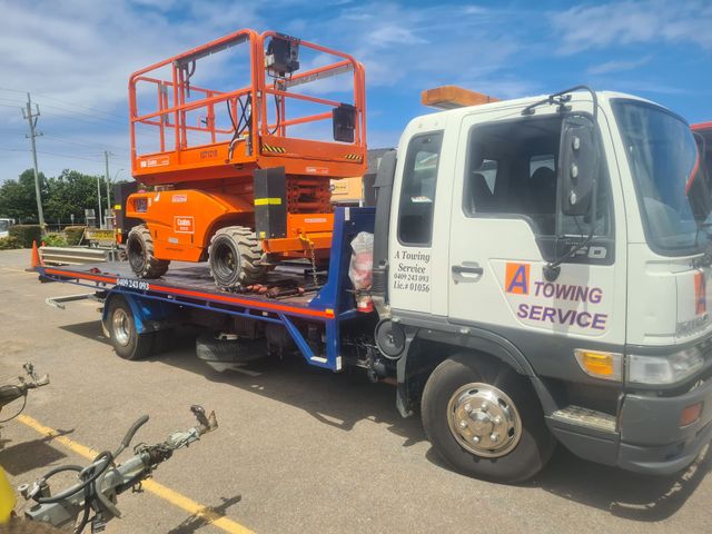 A Towing Service Truck is Carrying a Lift on the Back of It — A Towing Service In Forster, NSW