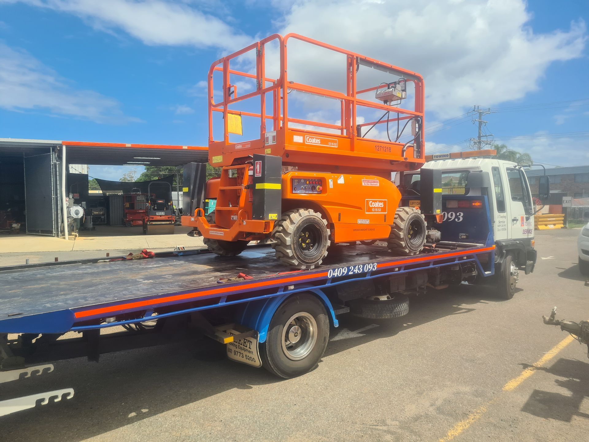 A Tow Truck is Carrying a Crane on the Back of It — A Towing Service In Gloucester, NSW
