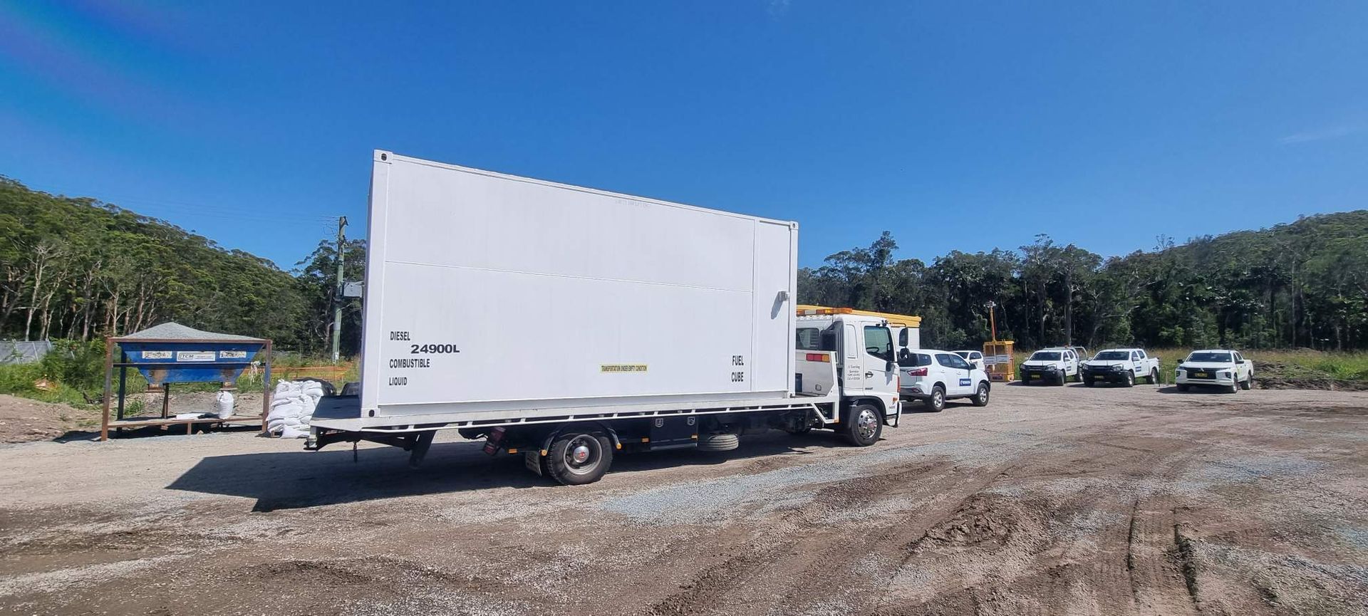 A White Truck is Parked in a Dirt Lot — A Towing Service In Forster, NSW
