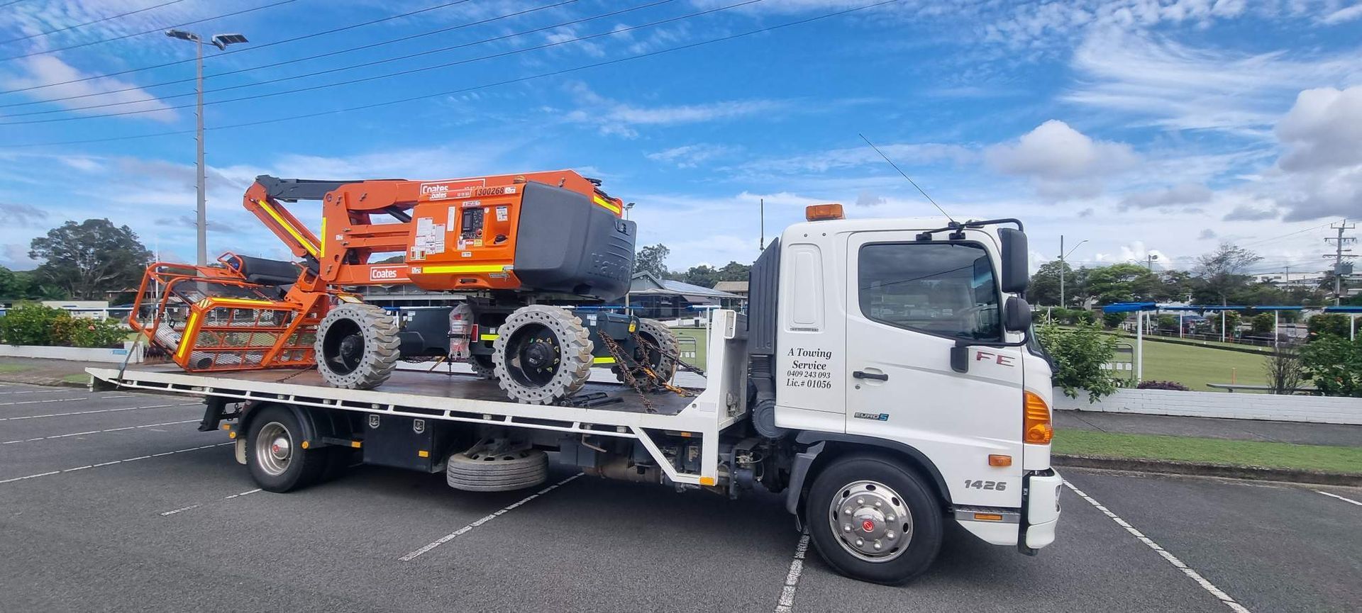 A Tow Truck With a Machine on the Back is Parked in a Parking Lot — A Towing Service In Bulahdelah, NSW
