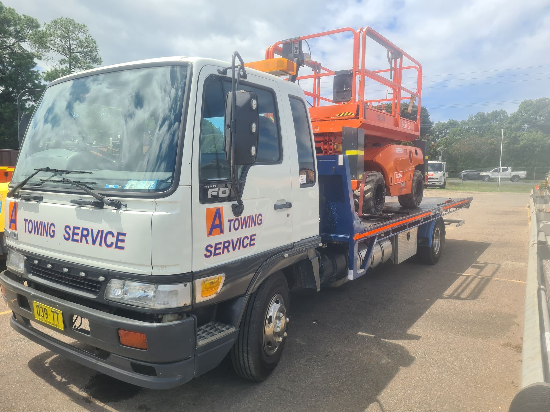 A Towing Service Truck With a Lift on the Back is Parked in a Parking Lot — A Towing Service In Nabiac, NSW