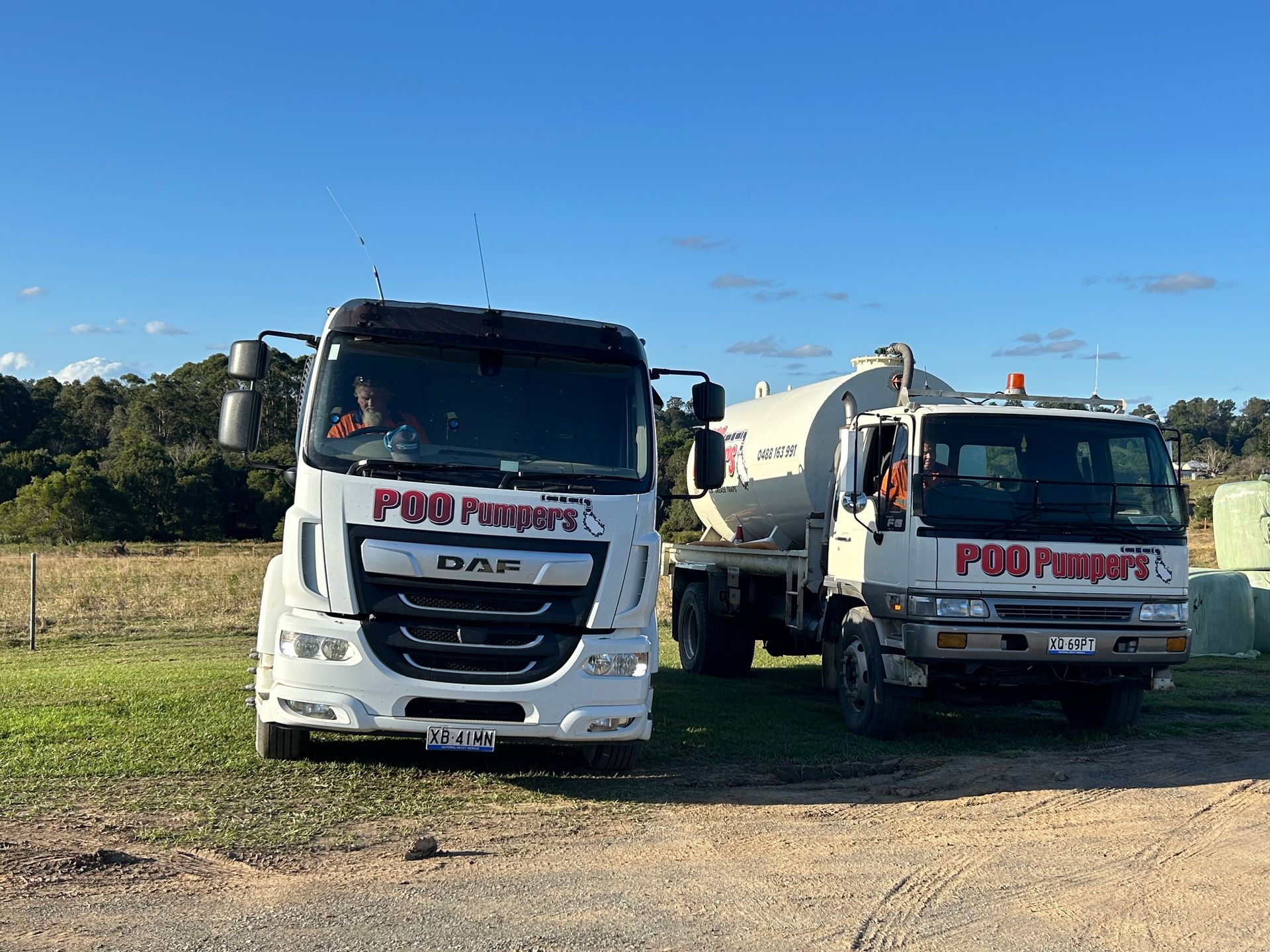 Septic Tank Trucks Next To Each Other — Gympie Poo Pumpers in Chatsworth, QLD