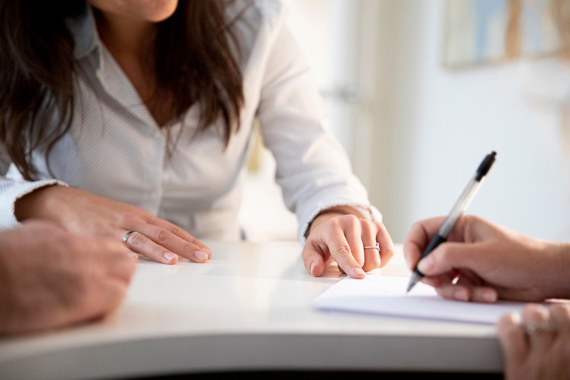 A woman is explaining a document to a client.