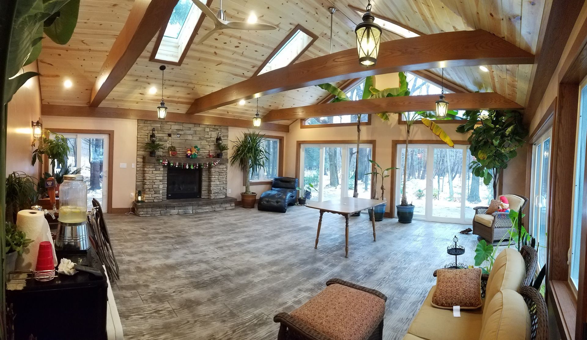 A large room with a fireplace and lots of windows