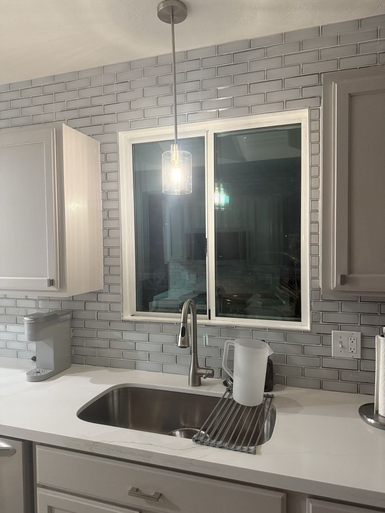 A kitchen with a sink , cabinets and a window