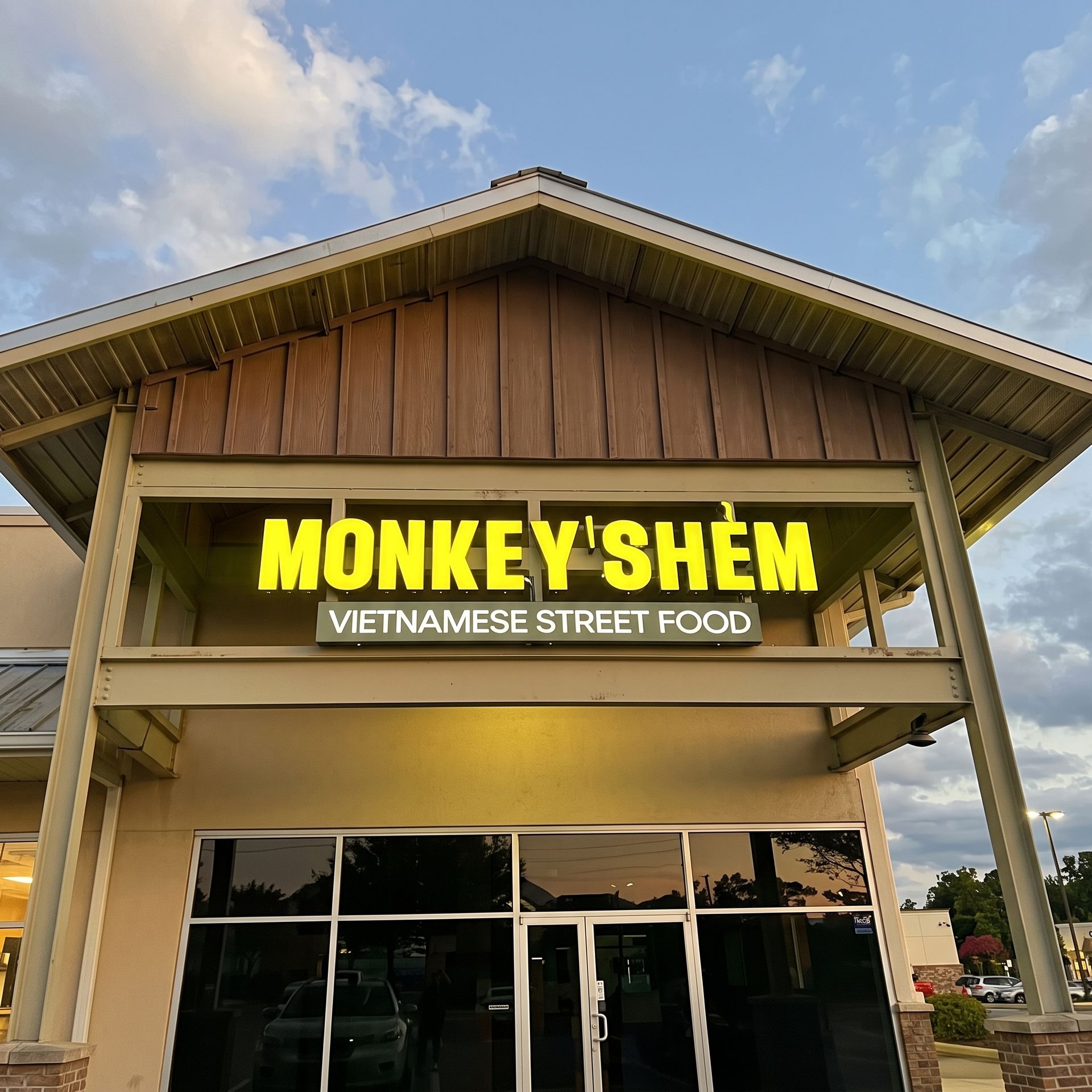 Storefront sign reading “MONKEY’S SHEM” with “Vietnamese Street Food” above glass doors.