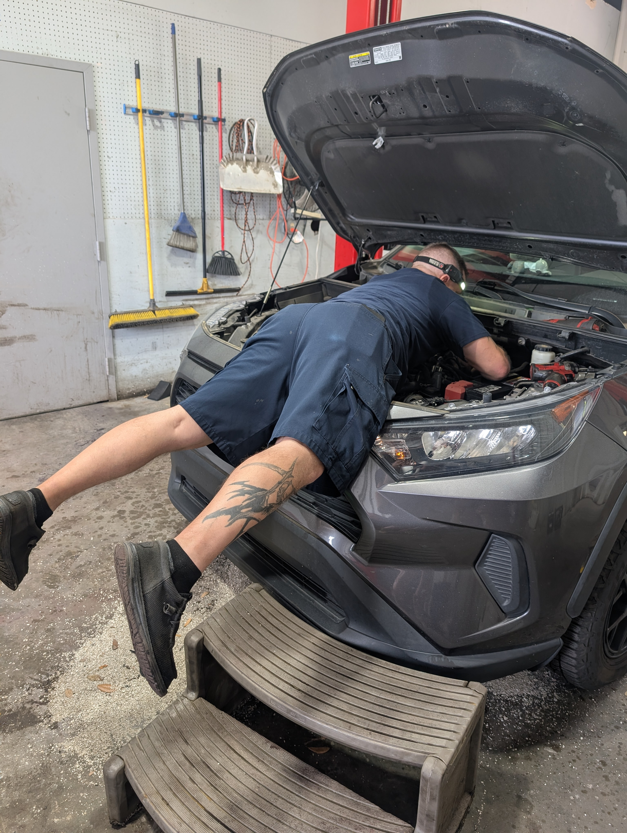 Our expert technician working deep in the engine of a car in our garage in Savannah, GA | CARma Auto Care