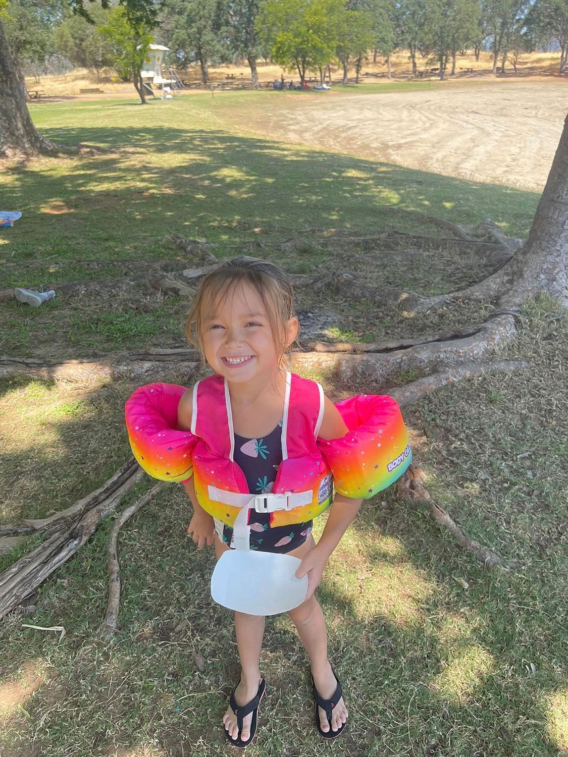 Cute Girl Wearing Swim Vest and Arm Floaties — Oroville, CA — Angela's Family Day Care