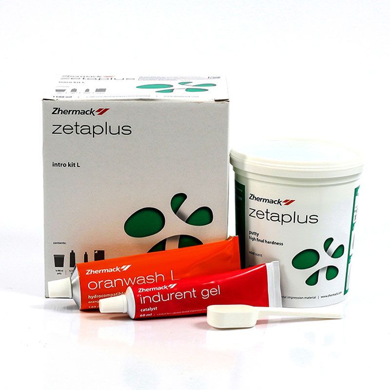 Caja, recipiente y tubos naranjas/rojos de materiales de impresión dental Zetaplus sobre fondo blanco.