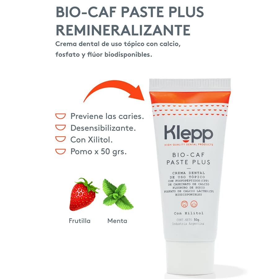 Envase de crema dental Klepp Bio-Car Paste Plus, blanco y naranja, con fresas ilustradas.