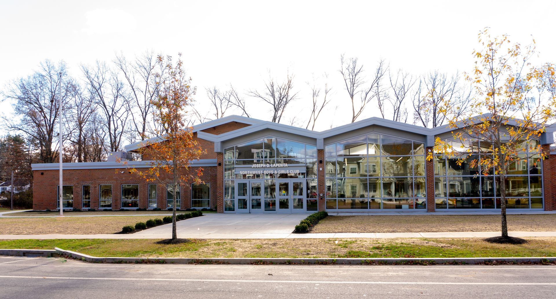 A large building with a lot of windows and trees in front of it