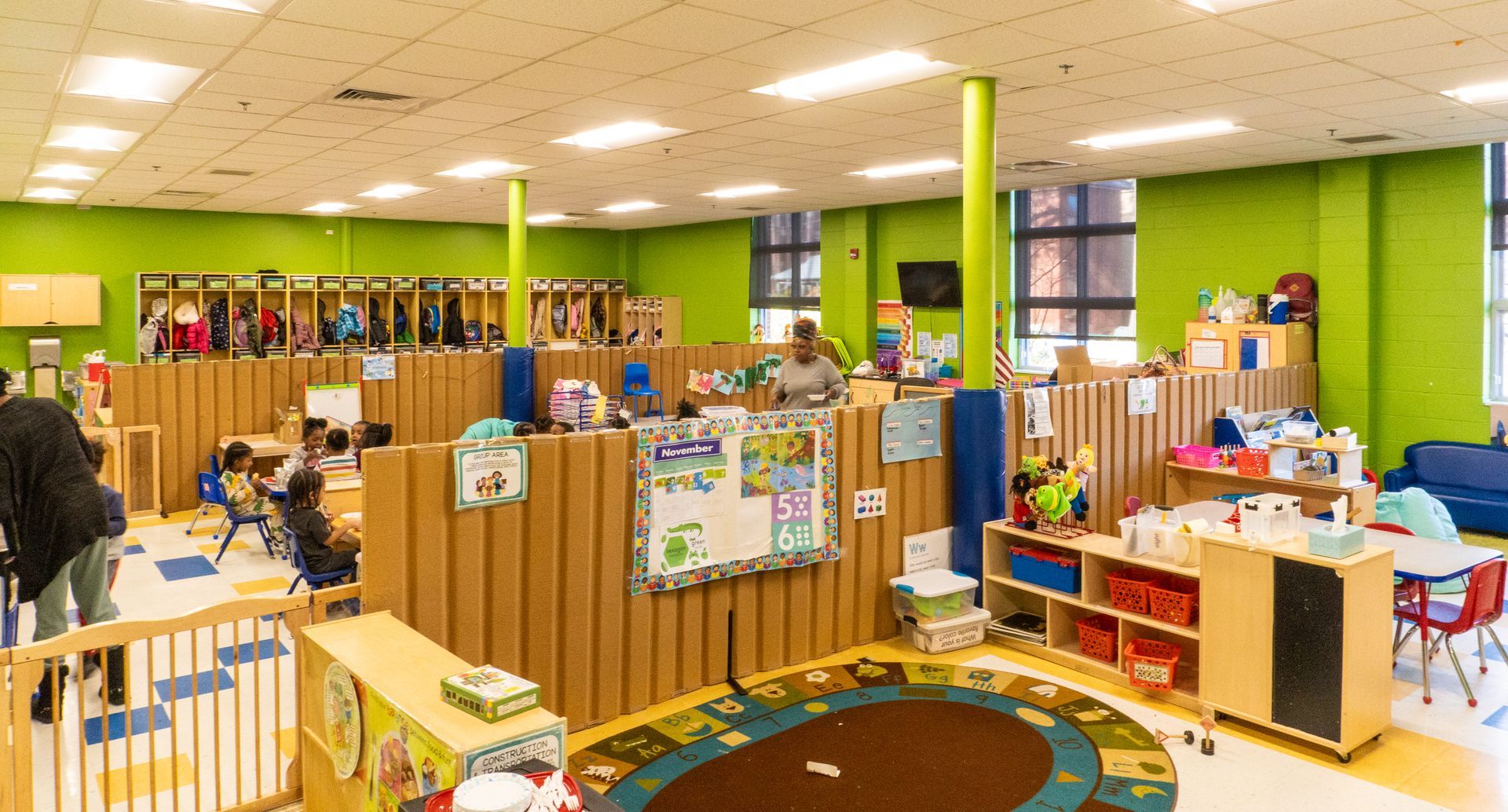 A large room with a lot of children playing in it.