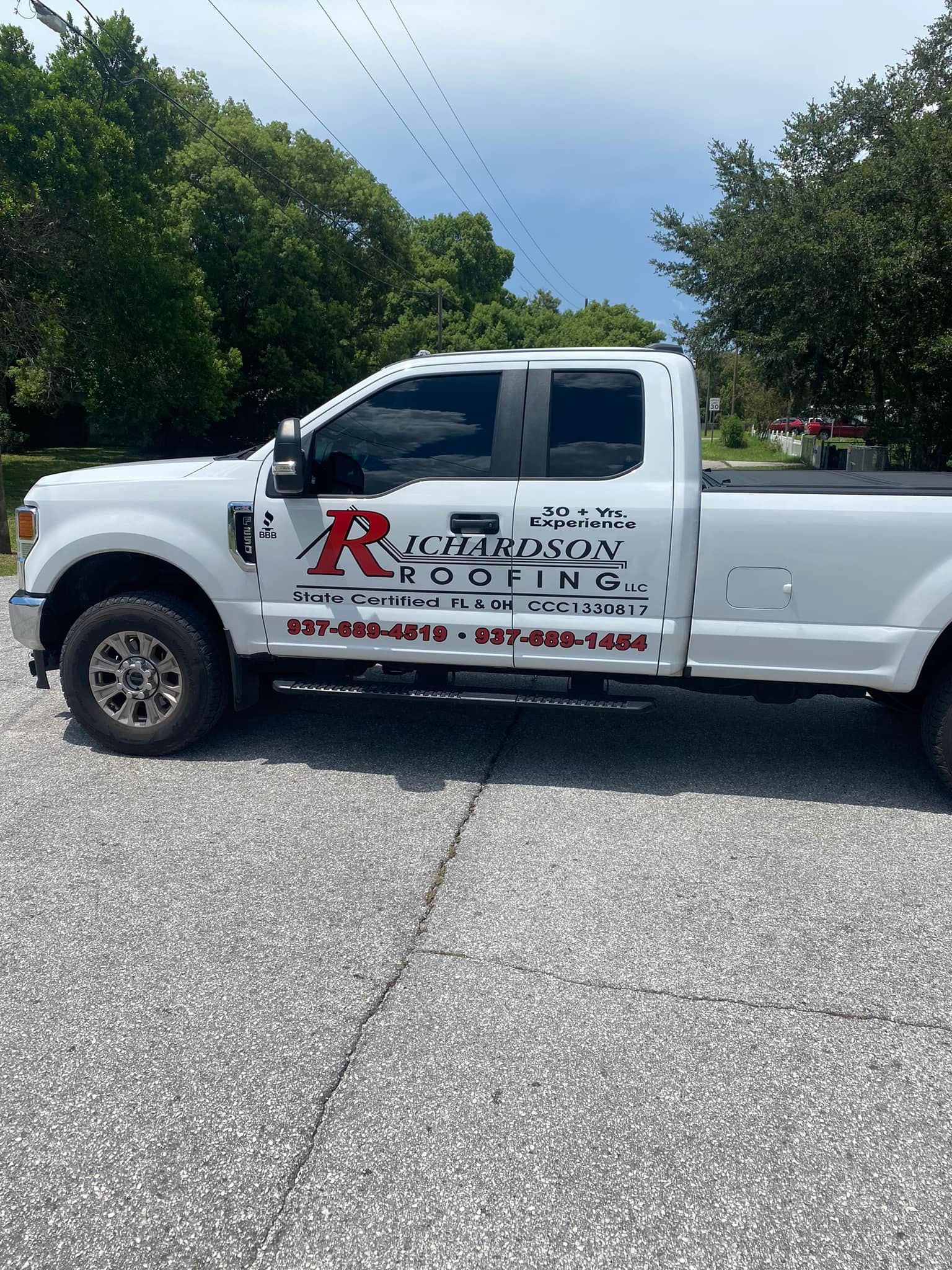 A white truck is parked on the side of the road.