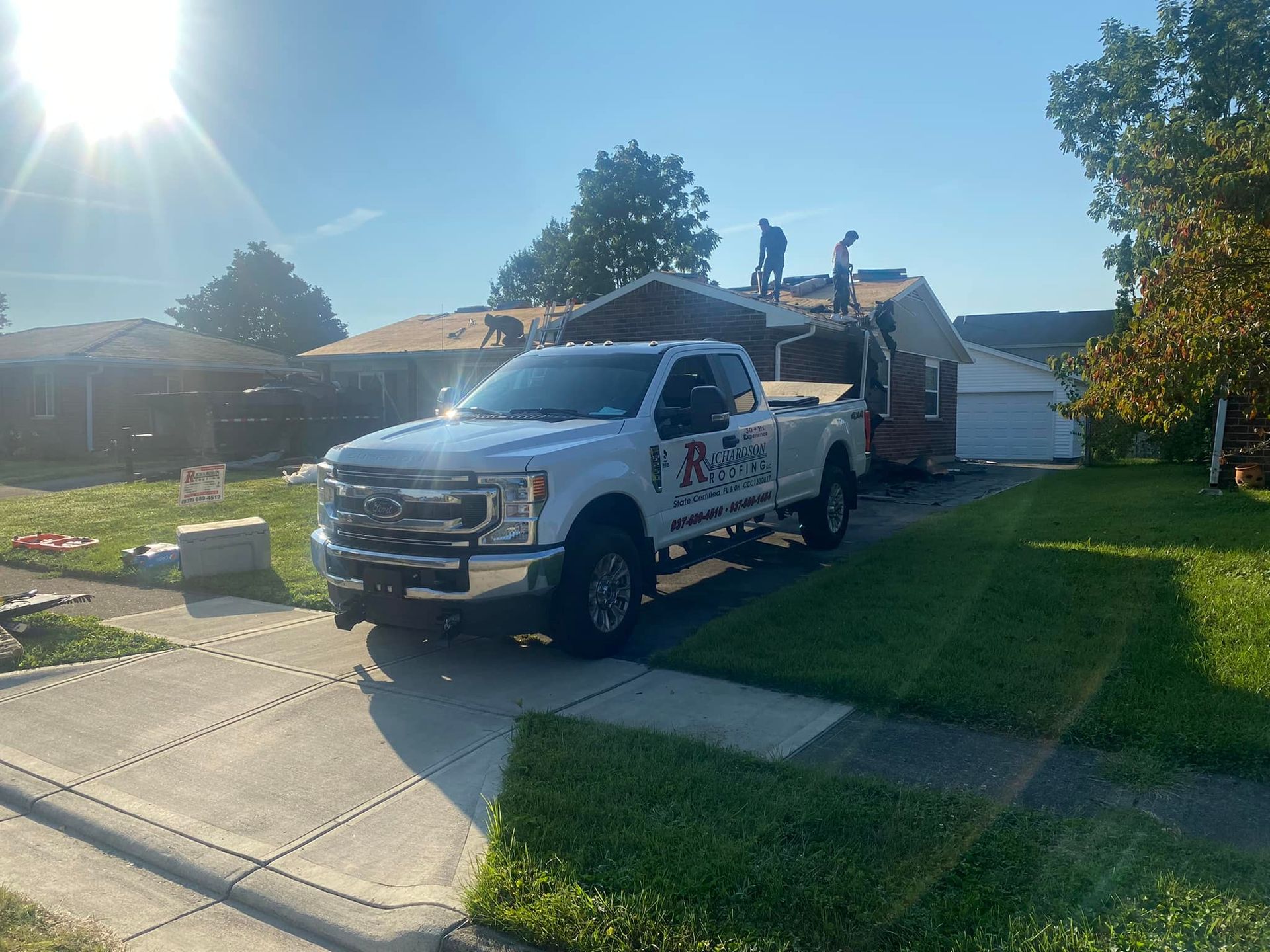 A white truck is parked in front of a house.