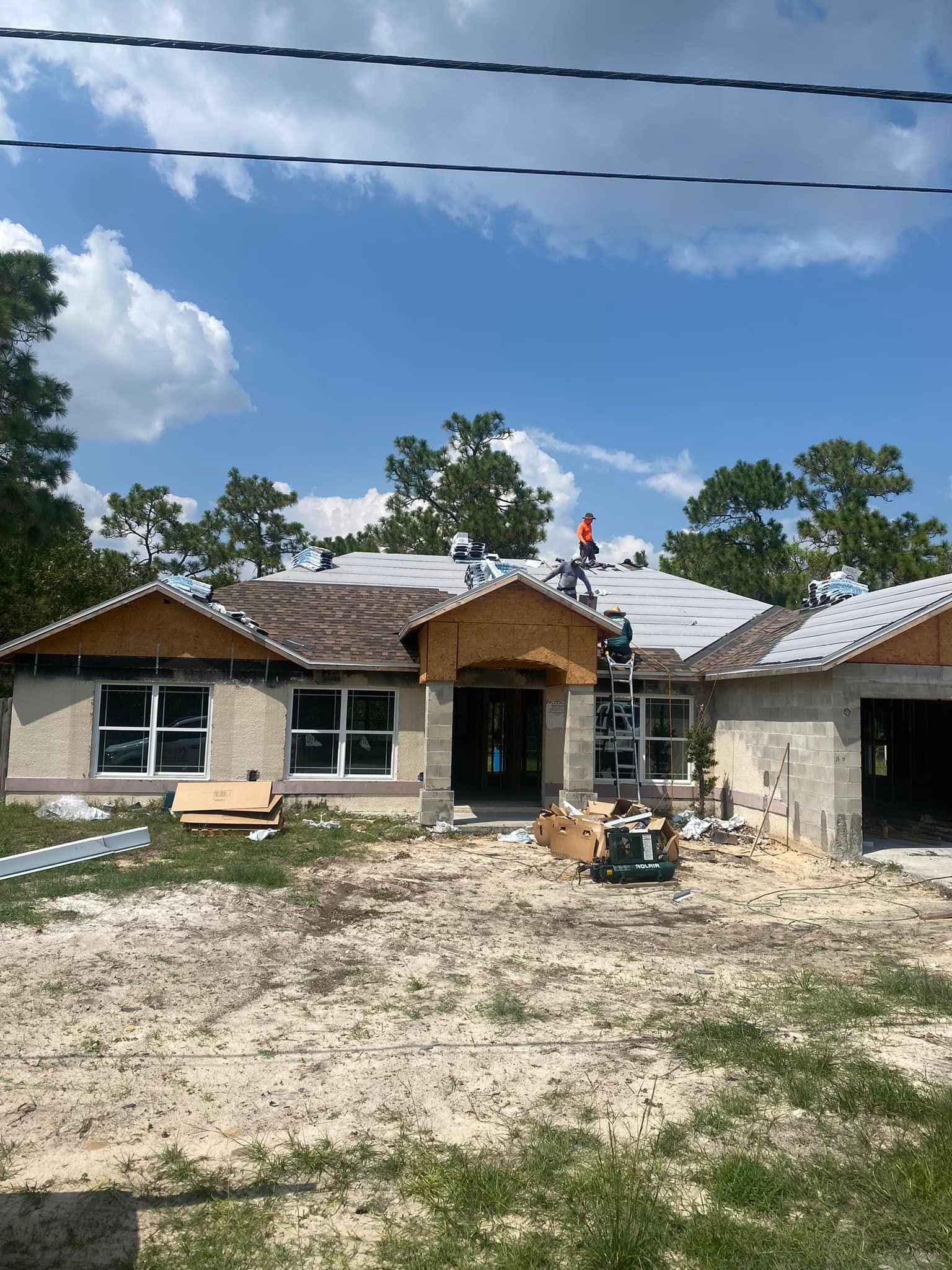 A house is being built in the middle of a dirt field.